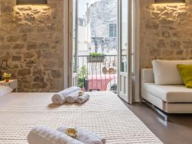 Rooms 2 bed and the stone wall of superior room 2